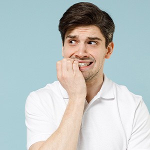Man biting his fingernails
