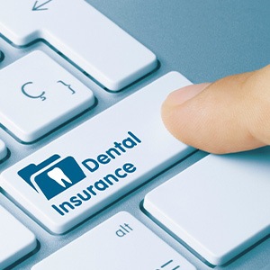 Person pressing on key that reads Dental Insurance