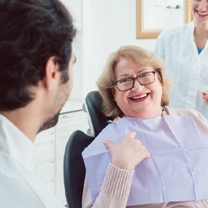 Woman visiting with her dentist and smiling